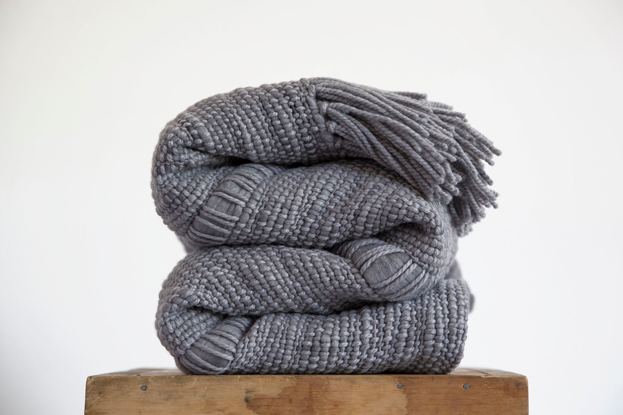 Grey knitted throw with pom online poms