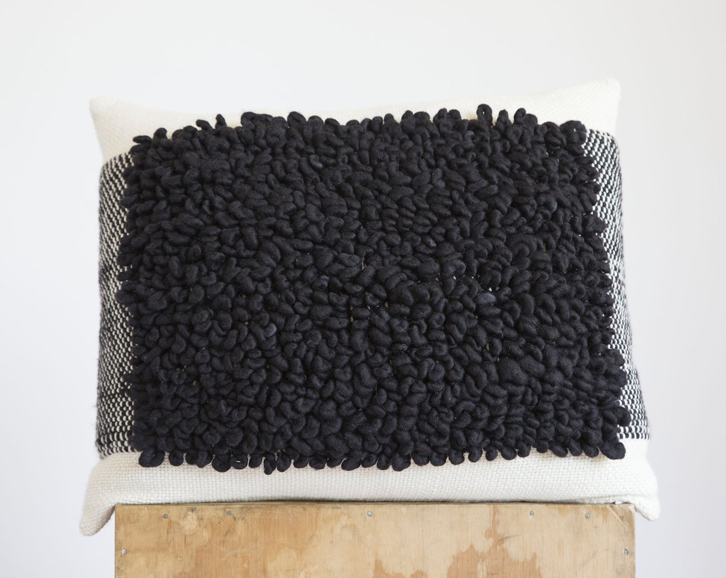 Ivory Merino wool woven cushion cover with textured tapestry loops in black