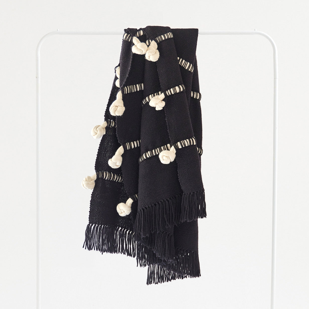 Limited edition Merino wool throw with handwoven knotted texture, crafted in Uruguay.