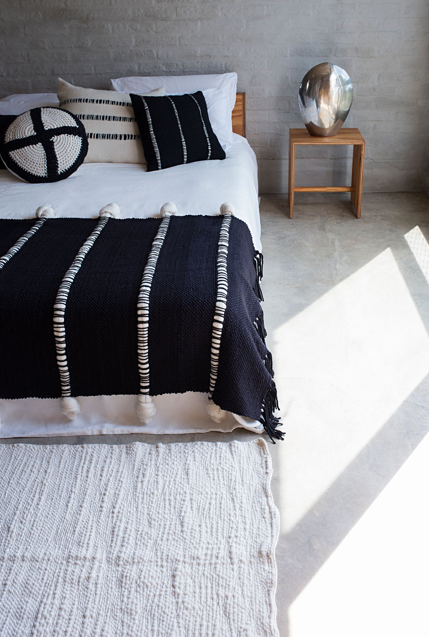 Knot Blanket showing sculptural surface and soft handwoven wool texture.