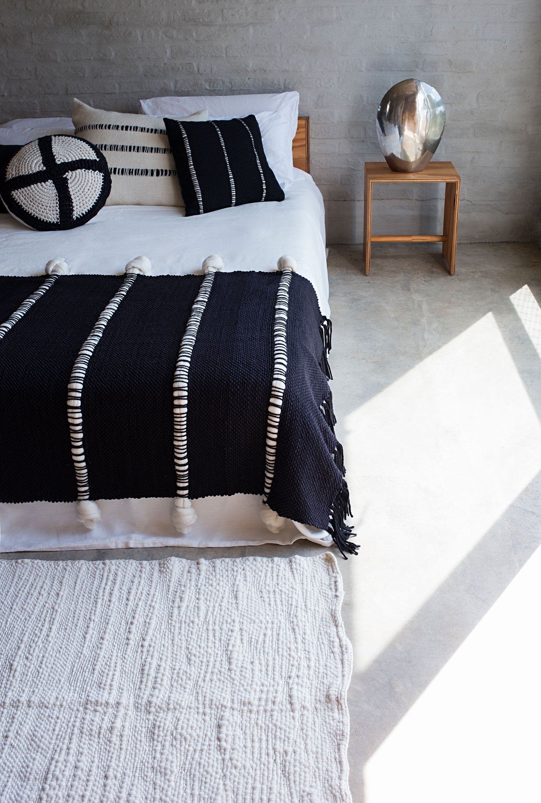 Knot Blanket showing sculptural surface and soft handwoven wool texture.