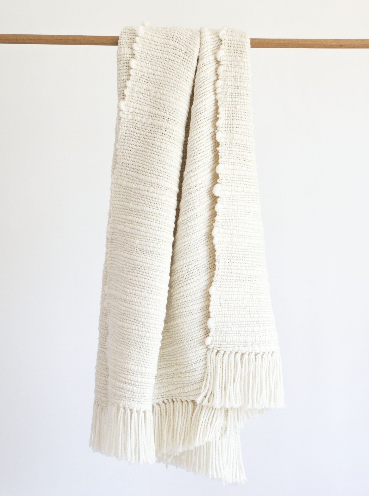 Ivory handwoven merino wool blanket with thick and thin yarn and fringes