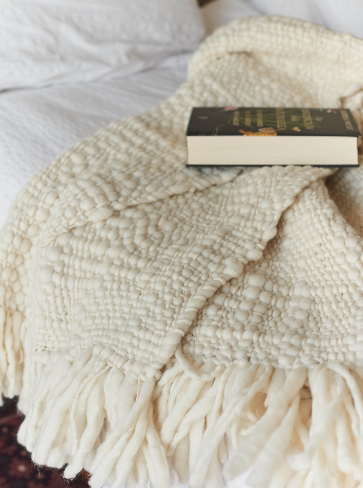 Handwoven Merino wool blanket in undyed ecru, crafted in Uruguay by women artisans.