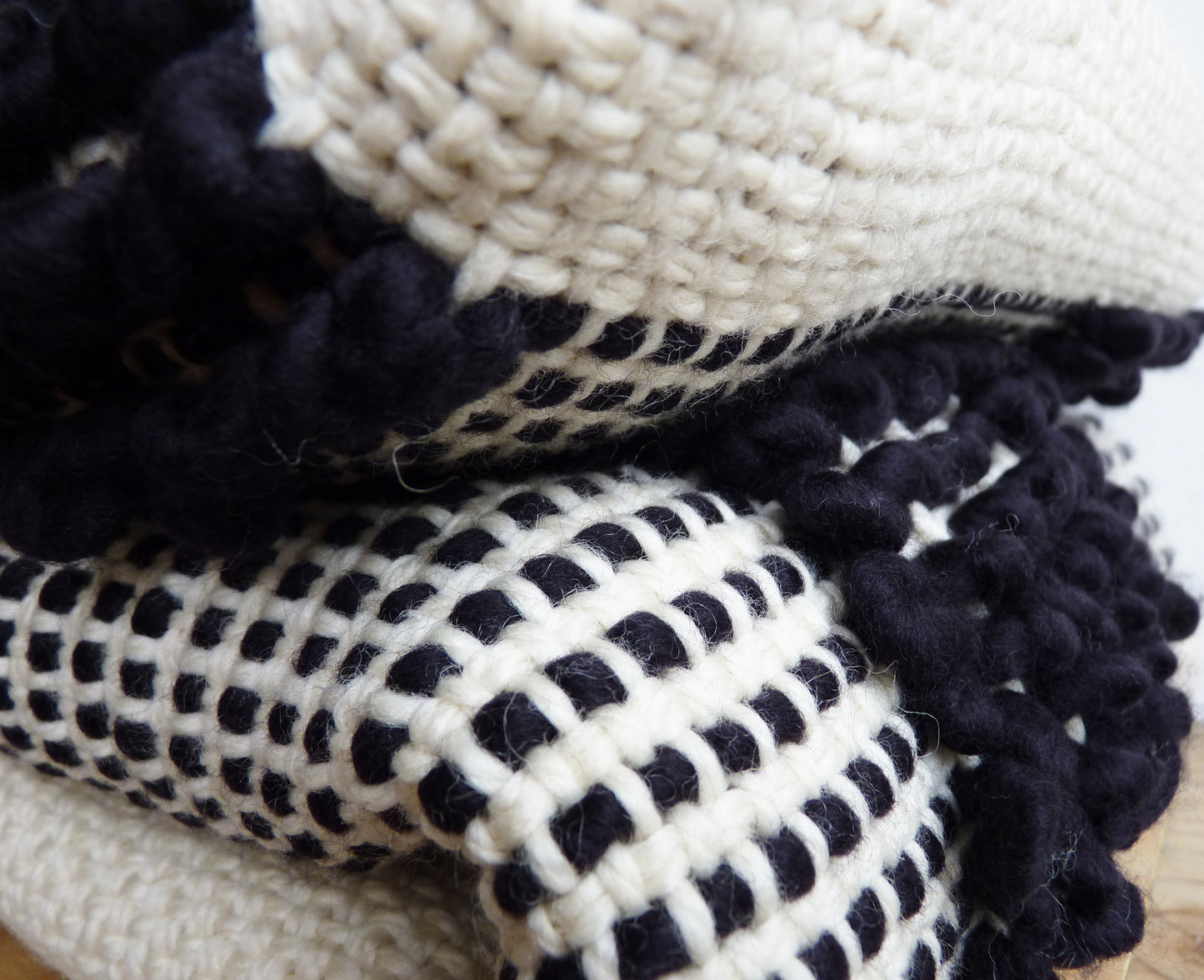 Ivory wool woven textil with black loops - Close shot